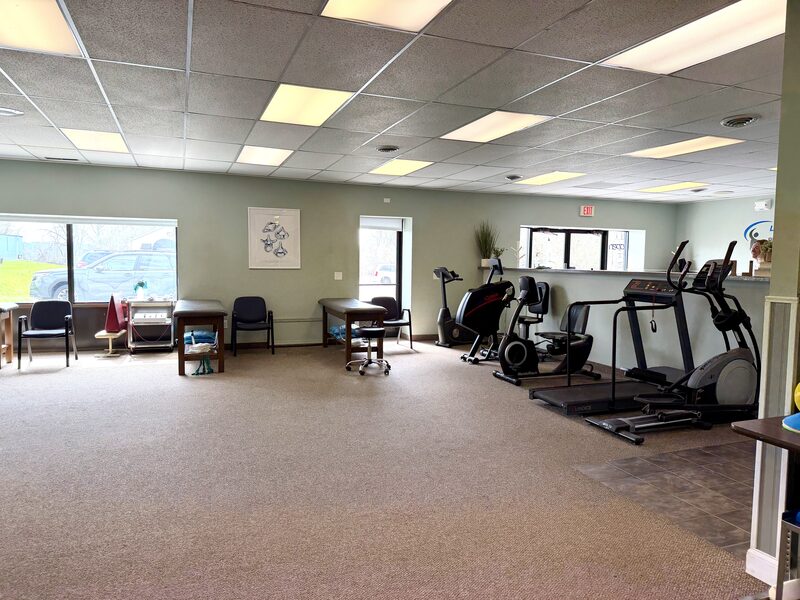 Cardio area with treadmill, bike, and elliptical by the windows