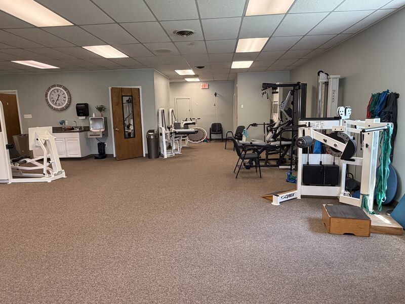 Open gym floor with strength-training equipment
