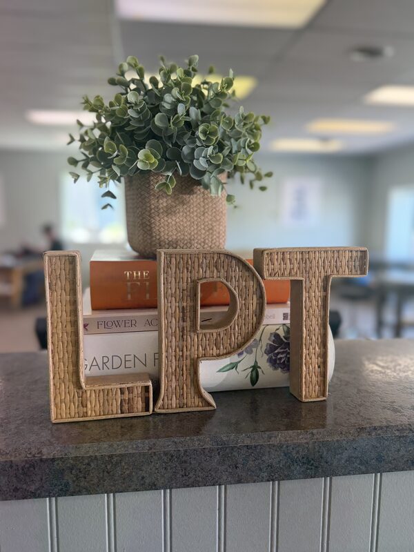 Handwoven LPT letters and greenery on the front desk